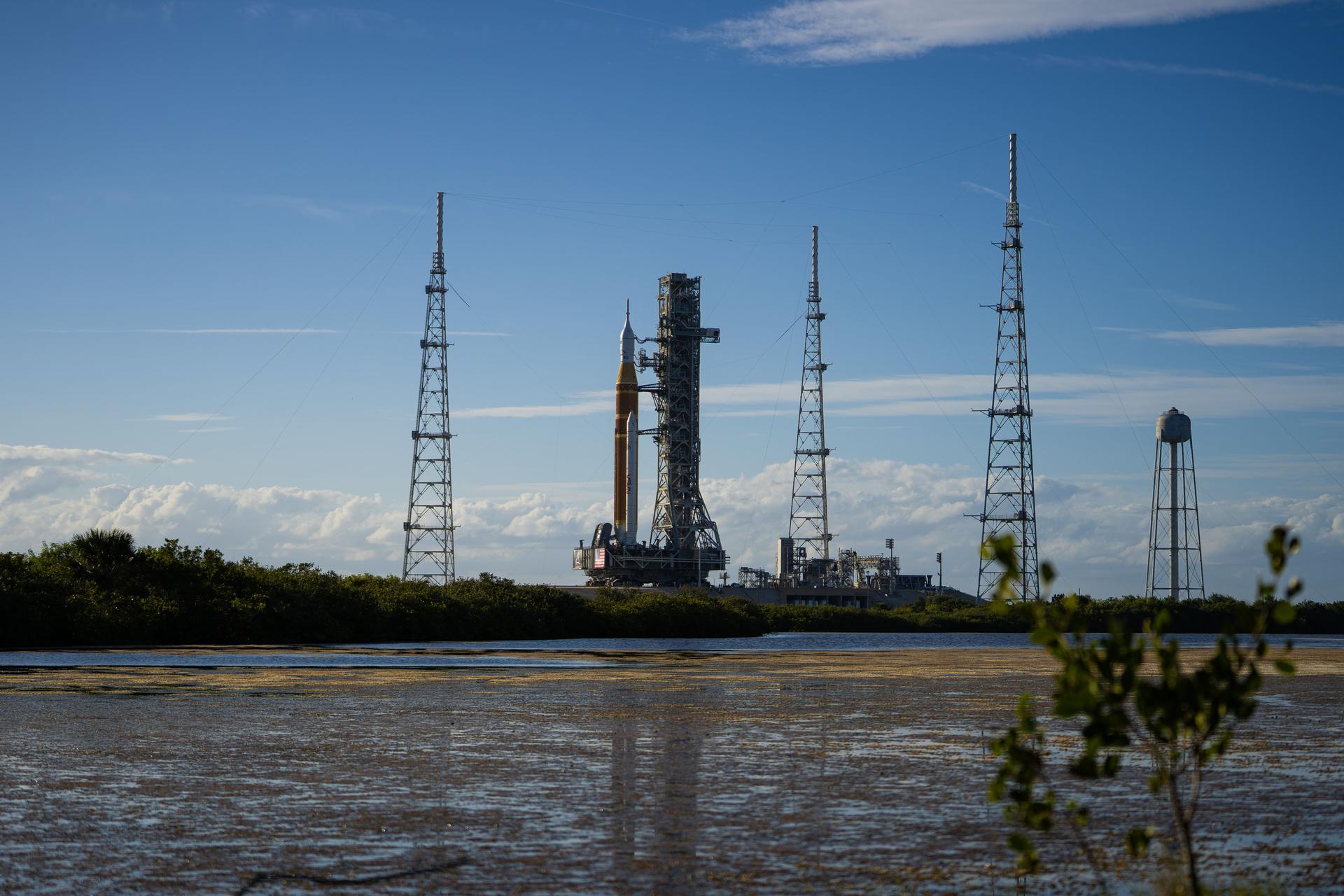 This image shows NASA’s SLS (Space Launch System) and Orion spacecraft rolling out of the Vehicle Assembly Building at NASA’s Kennedy Space Center. NASA's massive Crawler-Transporter, upgraded for the Artemis program, carries the powerful SLS rocket and Orion spacecraft on the Mobile Launcher from the Vehicle Assembly Building to Launch Pad 39B at Kennedy Space Center   in preparation for the Artemis II mission.  